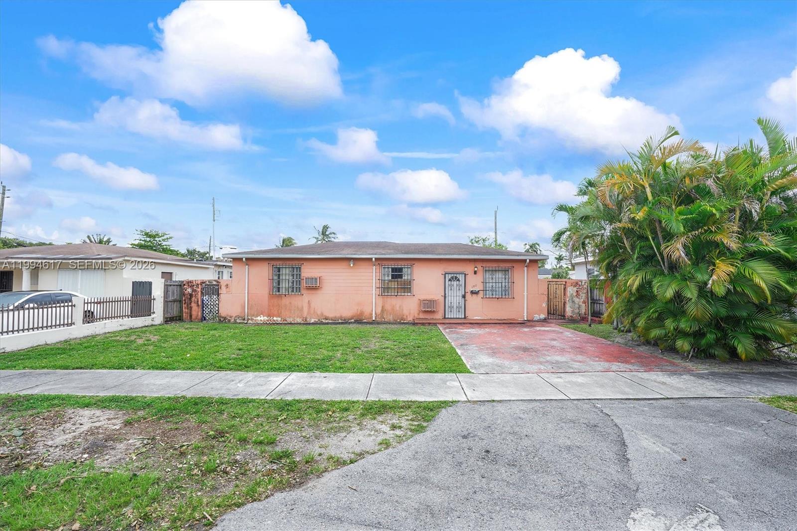 6810 Southwest 1st Street Miami, FL 33144 - Photo 1 of 17 a front view of a house with a garden and yard