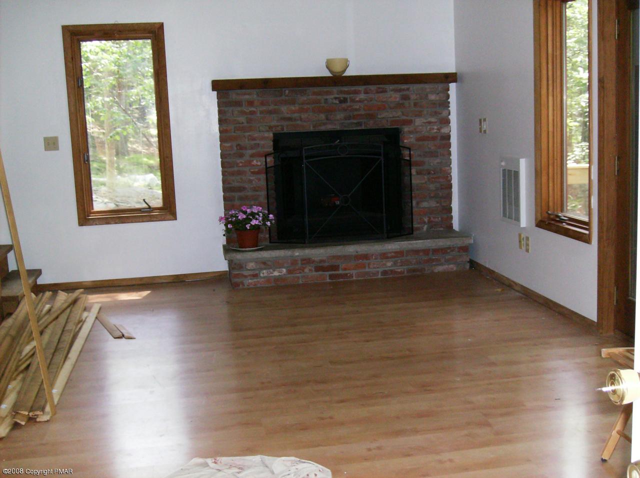 2727 Radcliff Road Bushkill, PA 18324 - Photo 3 of 14 a view of an empty room with wooden floor and a window