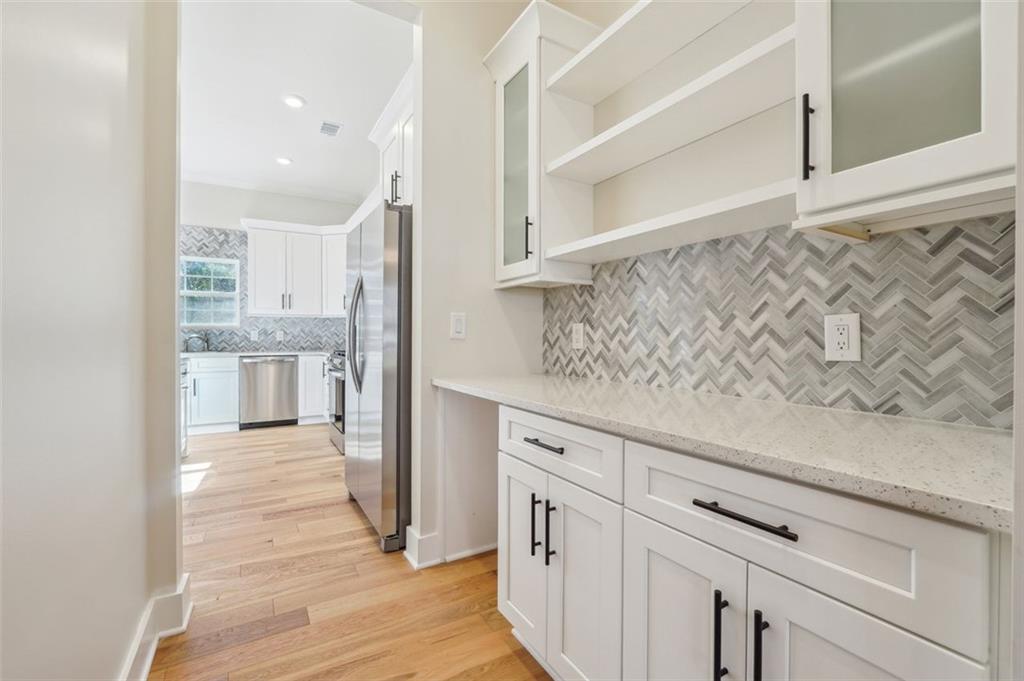 1620 Derry Avenue Southwest Atlanta, GA 30310 - Photo 11 of 47 a kitchen with white cabinets and wooden floor