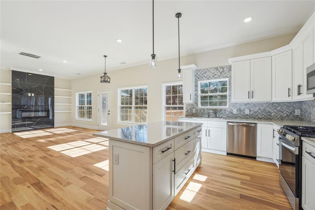 1620 Derry Avenue Southwest Atlanta, GA 30310 - Photo 12 of 47 a kitchen with stainless steel appliances granite countertop a stove and a sink