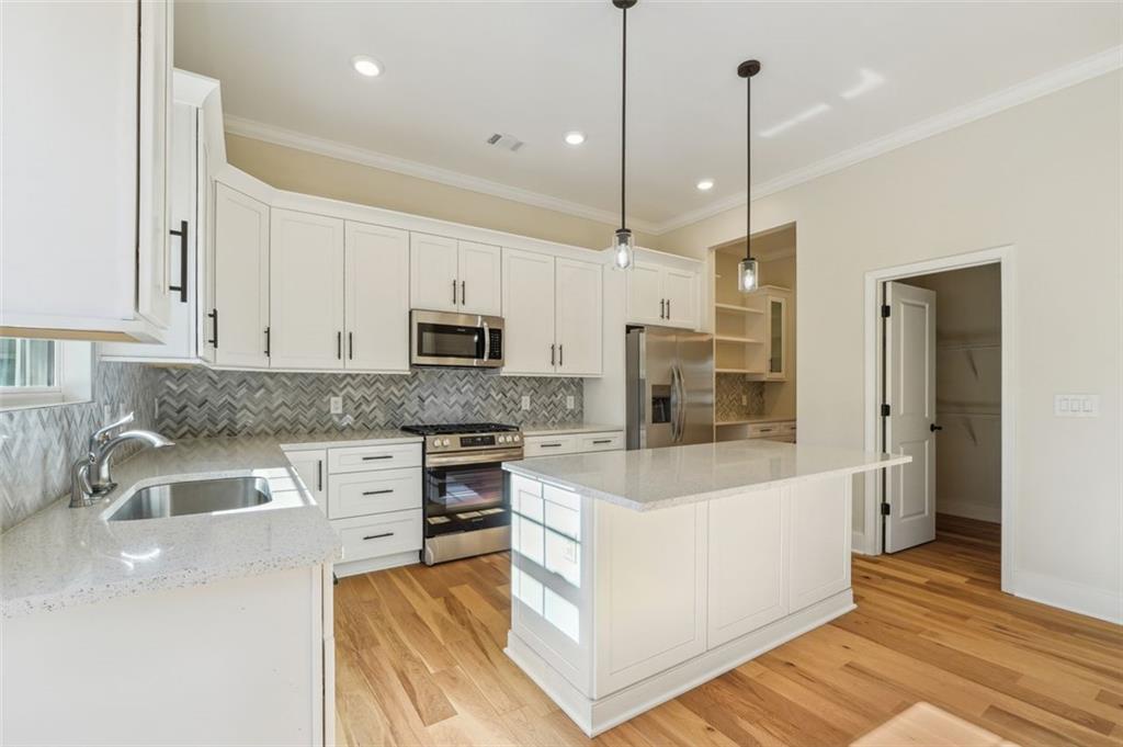 1620 Derry Avenue Southwest Atlanta, GA 30310 - Photo 15 of 47 a large white kitchen with stainless steel appliances