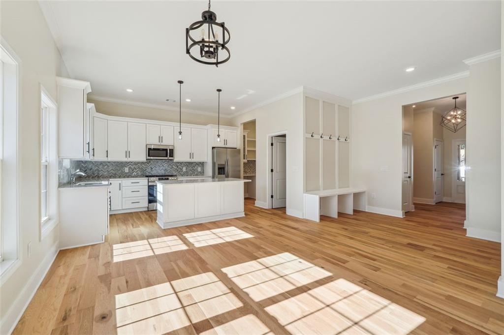 1620 Derry Avenue Southwest Atlanta, GA 30310 - Photo 17 of 47 a large white kitchen with kitchen island a sink stainless steel appliances and cabinets