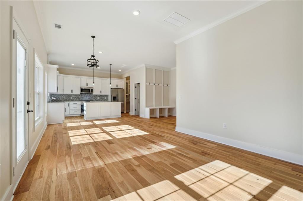 1620 Derry Avenue Southwest Atlanta, GA 30310 - Photo 22 of 47 a view of a kitchen with kitchen island white cabinets and wooden floor