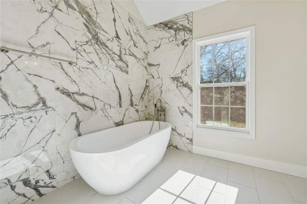1620 Derry Avenue Southwest Atlanta, GA 30310 - Photo 30 of 47 a white bath tub sitting in a bathroom next to a window