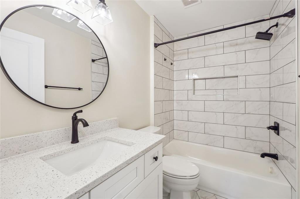 1620 Derry Avenue Southwest Atlanta, GA 30310 - Photo 31 of 47 a bathroom with a sink a toilet and a mirror