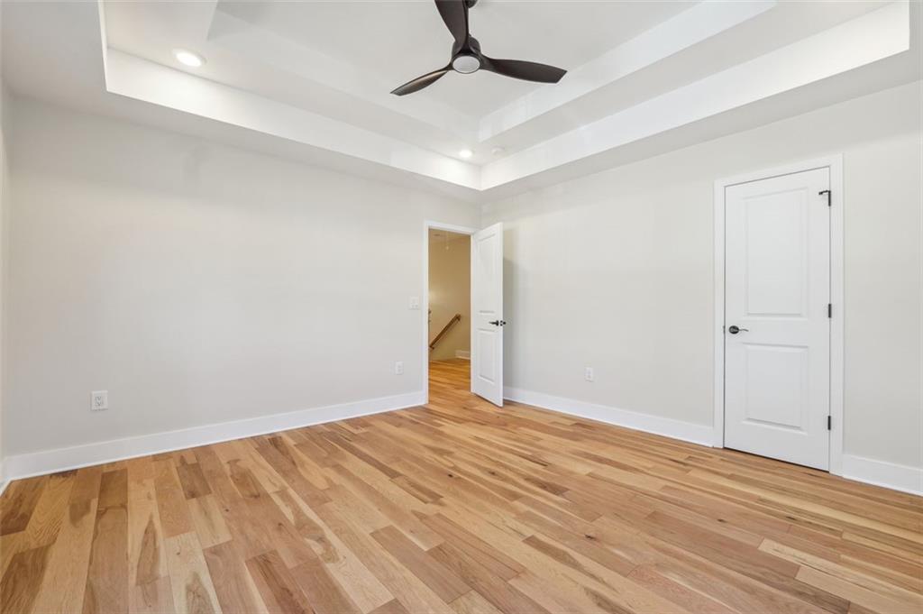 1620 Derry Avenue Southwest Atlanta, GA 30310 - Photo 33 of 47 a view of an empty room with wooden floor and a ceiling fan