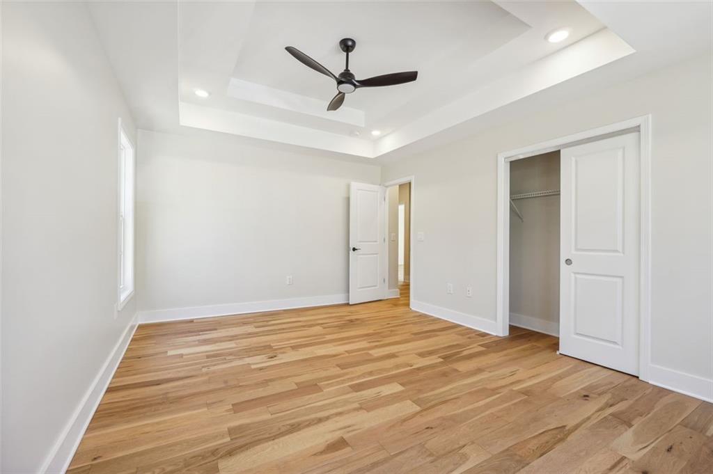 1620 Derry Avenue Southwest Atlanta, GA 30310 - Photo 36 of 47 an empty room with wooden floor and ceiling fan