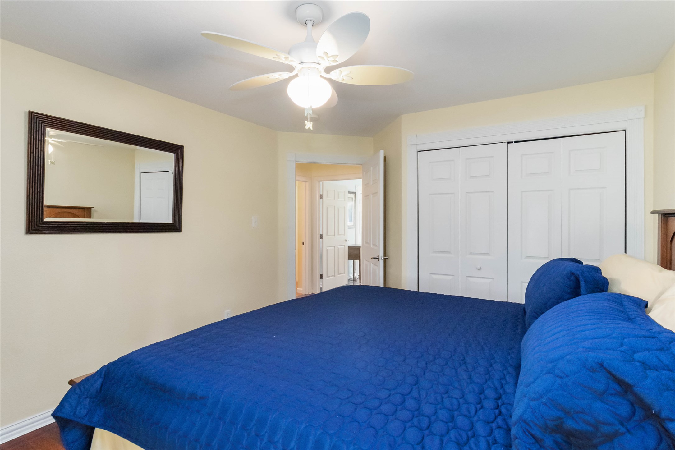 1208 Jeddo Road Rosanky, TX 78953 - Photo 18 of 40 Relaxation awaits in this bedroom, complete with a convenient closet and ceiling fan for optimal comfort.