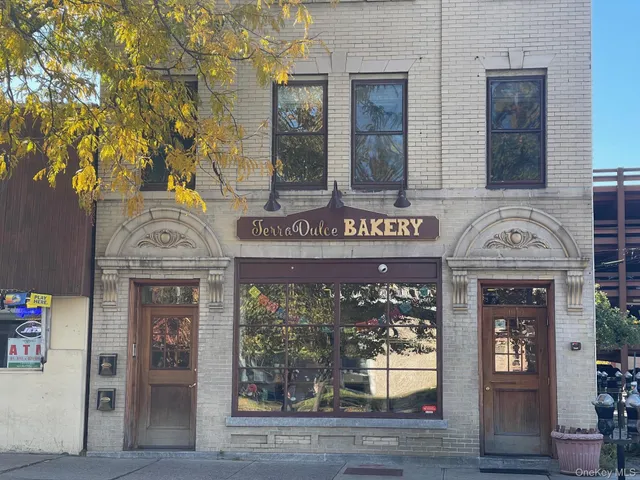 a large kitchen with stainless steel appliances granite countertop a refrigerator and a sink