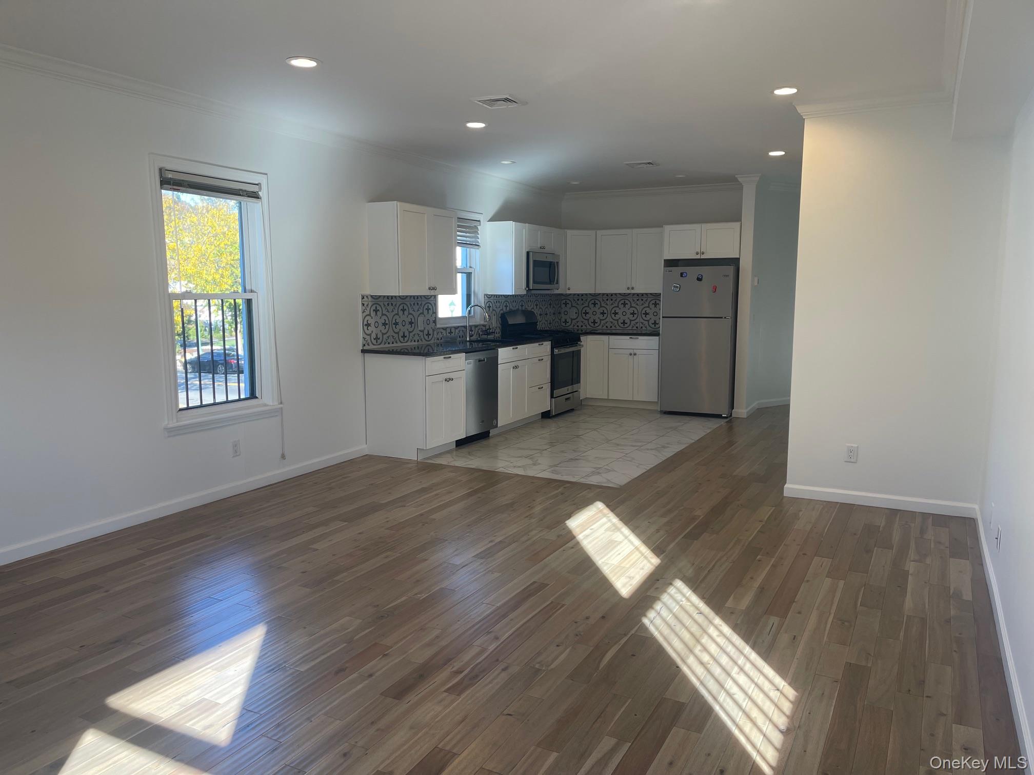 1049 Main Street, Unit 2 Peekskill, NY 10566 - Photo 2 of 9 a large kitchen with stainless steel appliances granite countertop a refrigerator and a sink