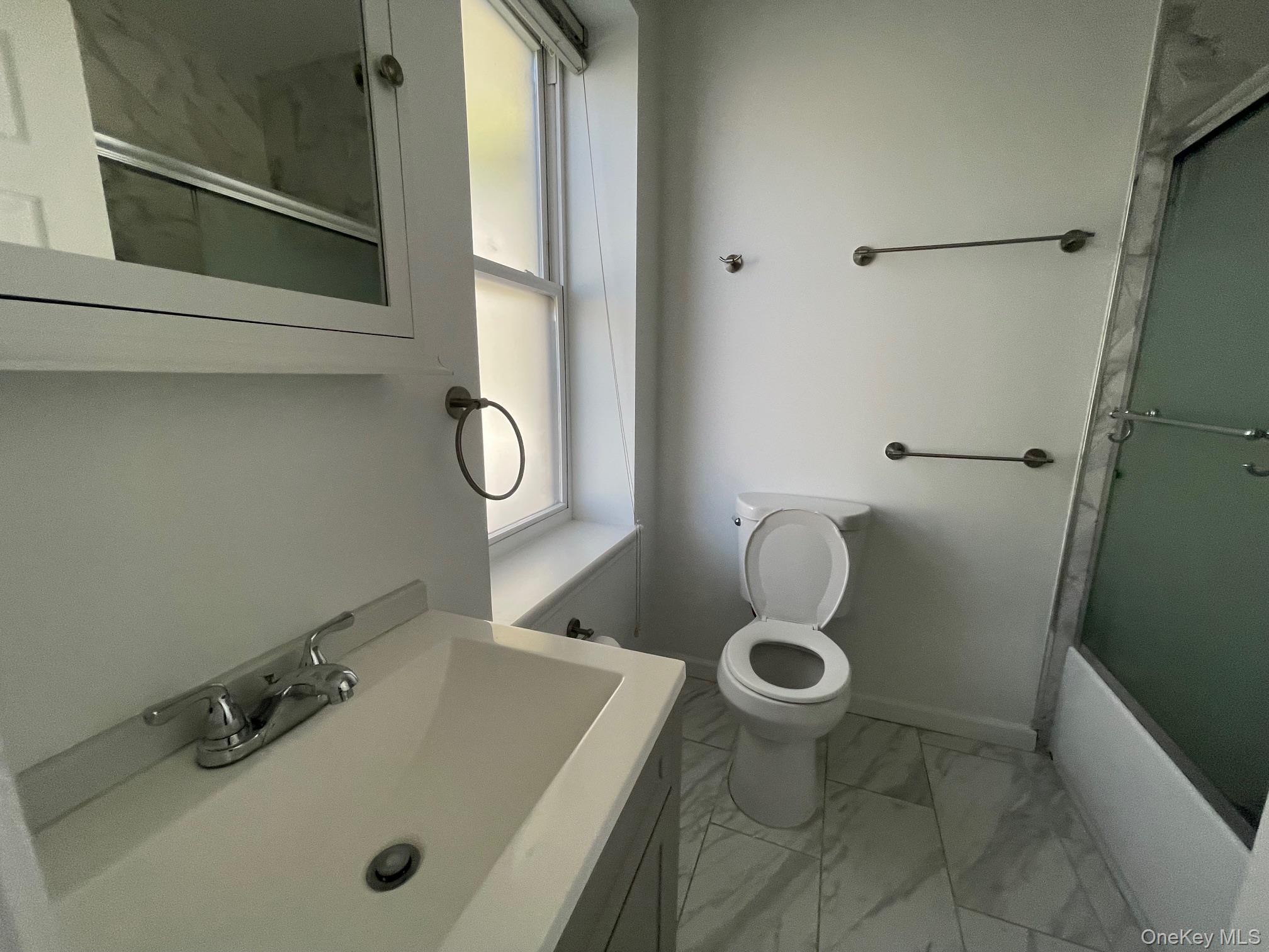 1049 Main Street, Unit 2 Peekskill, NY 10566 - Photo 7 of 9 a bathroom with a sink and a toilet