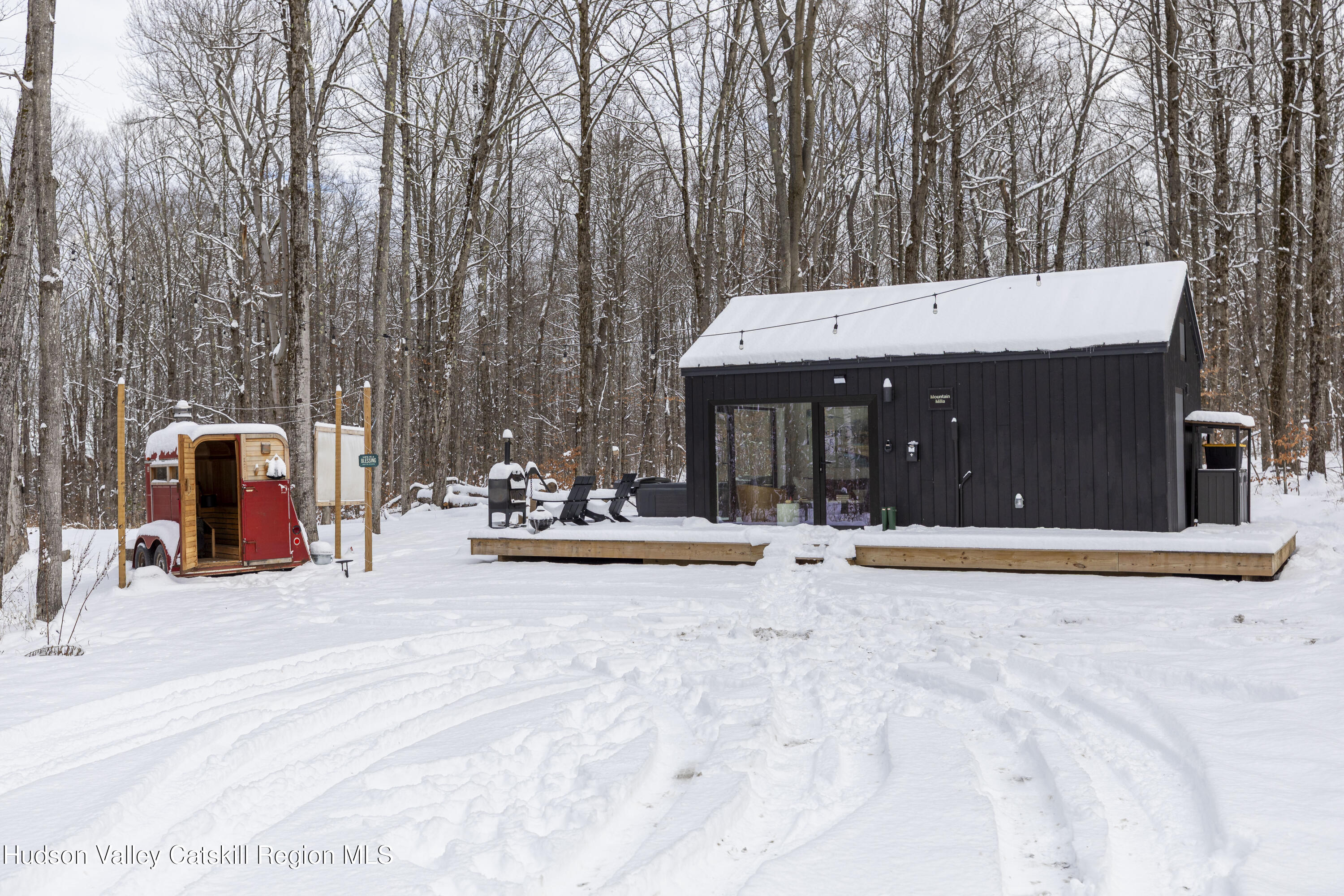 a view of a swimming pool with a patio and a fire pit
