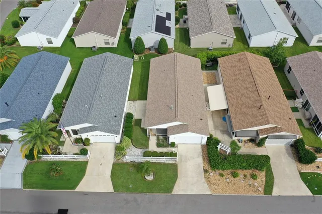 an aerial view of a house with a garden and trees