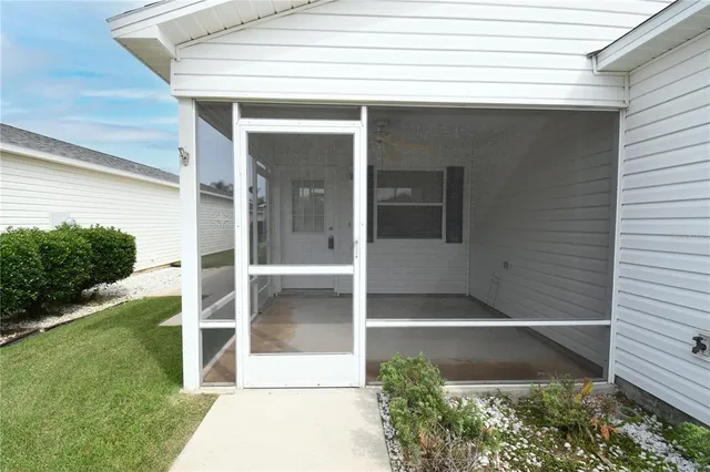 a view of yellow house with a large window