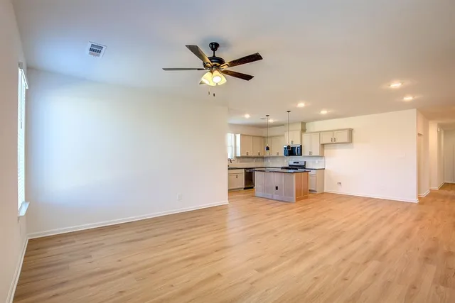 a view of kitchen with wooden floor and a window