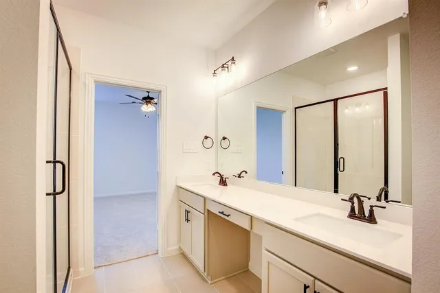 a bathroom with a double vanity sink mirror and double