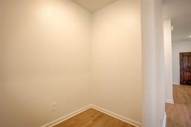 a view of a small space with wooden floor