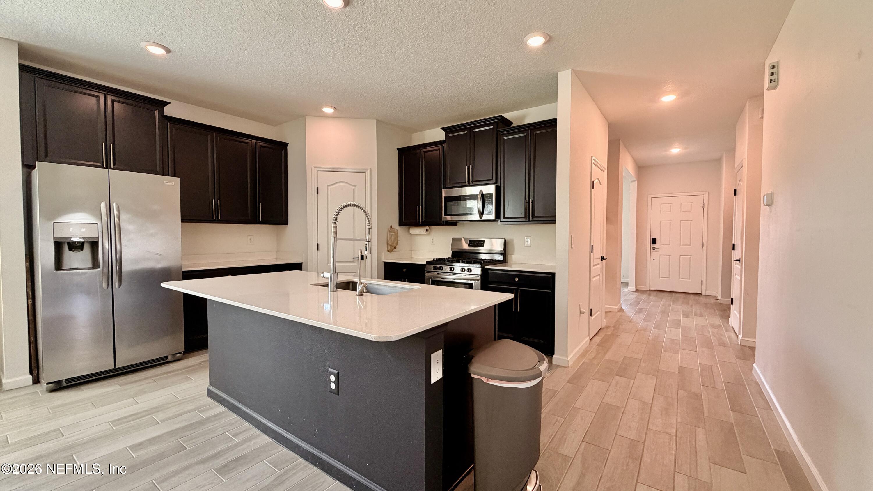 37 Saba Lane St. Augustine, FL 32092 - Photo 14 of 42 a kitchen with kitchen island a sink appliances and cabinets