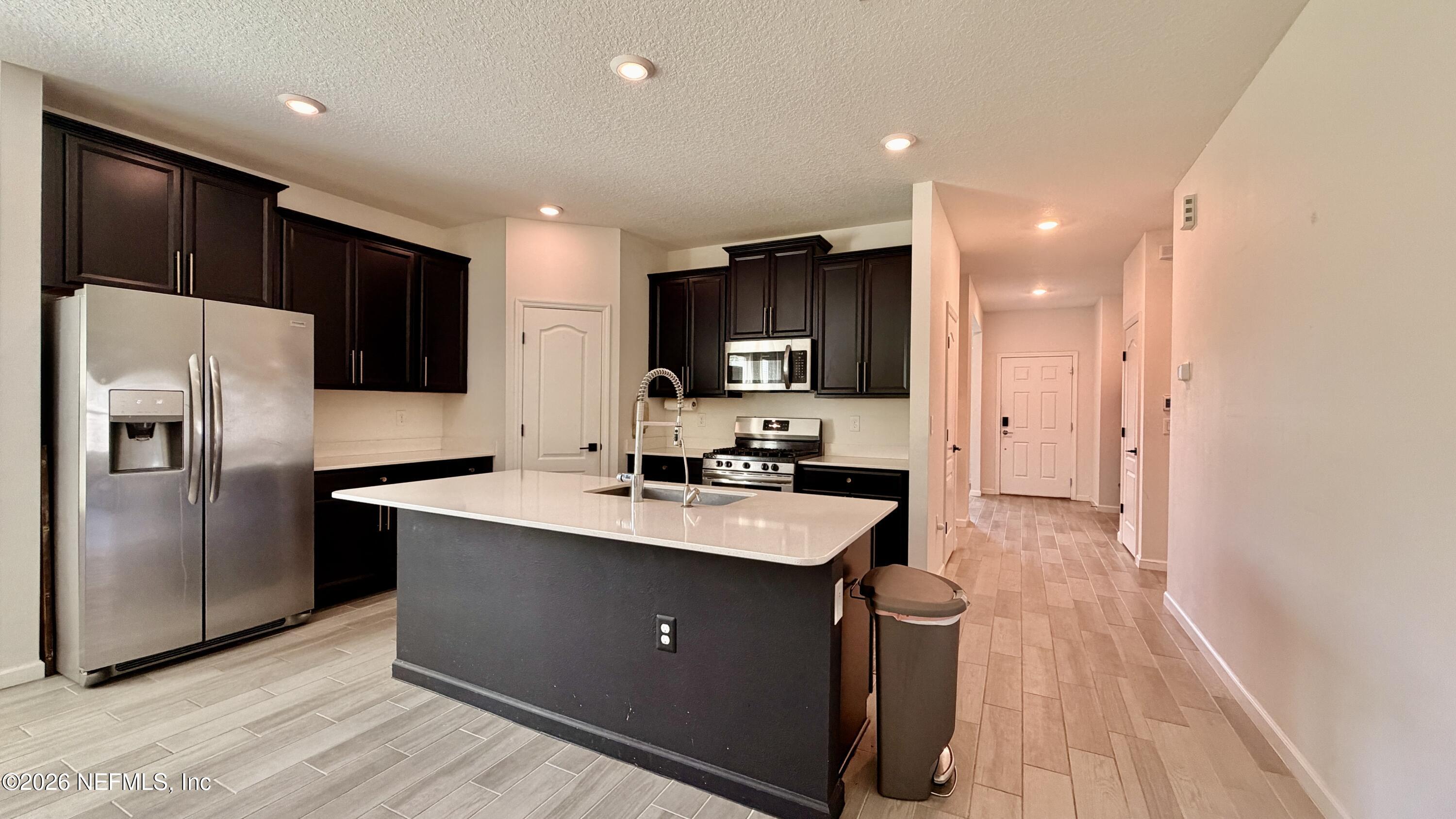 37 Saba Lane St. Augustine, FL 32092 - Photo 15 of 42 a kitchen with kitchen island a sink stainless steel appliances and cabinets