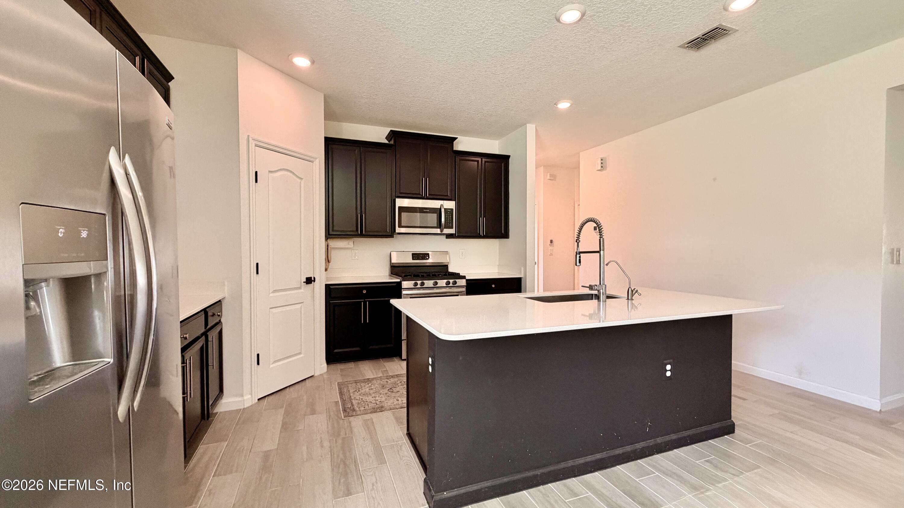 37 Saba Lane St. Augustine, FL 32092 - Photo 17 of 42 a kitchen with stainless steel appliances a sink stove and refrigerator