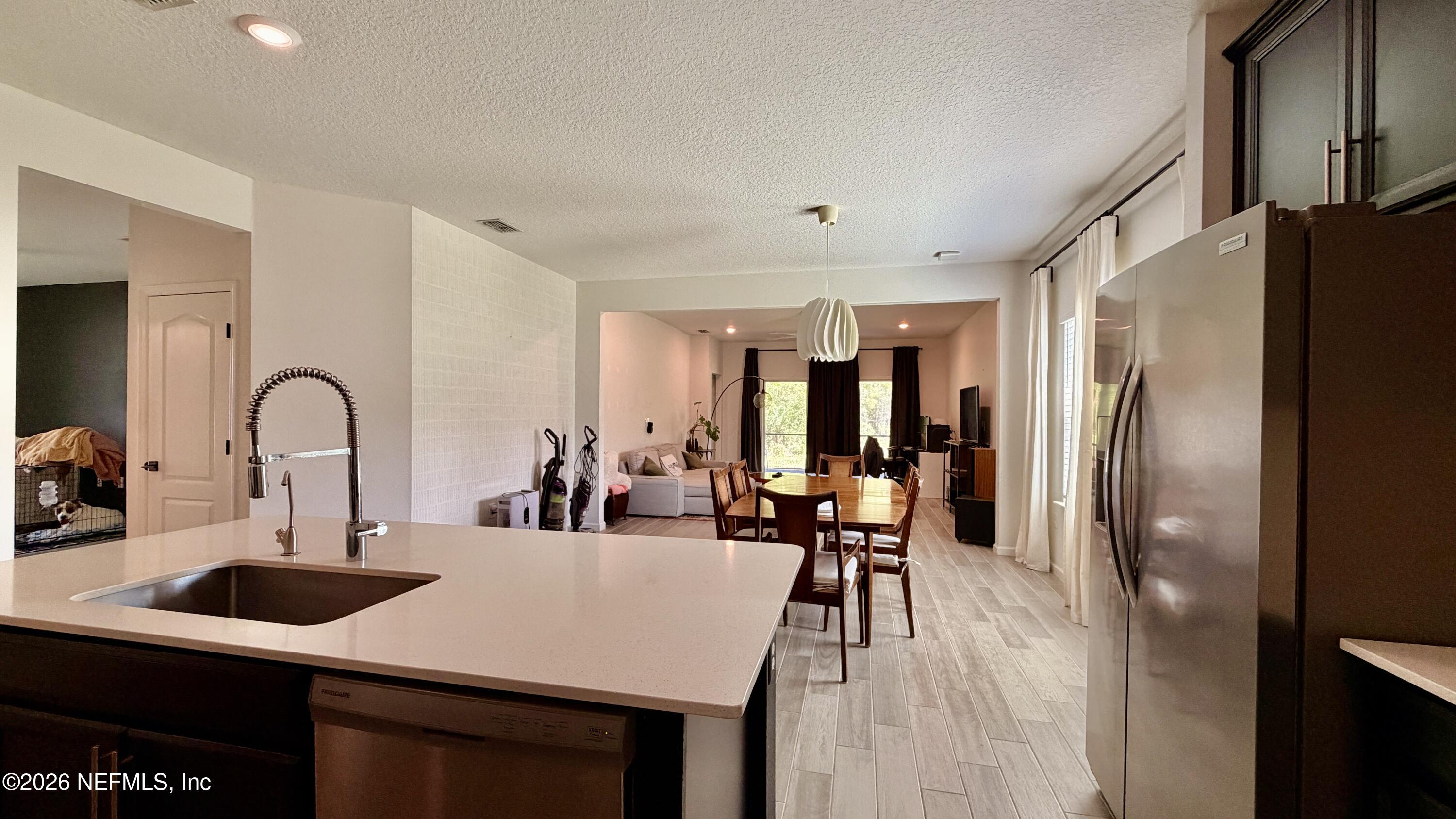 37 Saba Lane St. Augustine, FL 32092 - Photo 19 of 42 a kitchen with stainless steel appliances a table and chairs