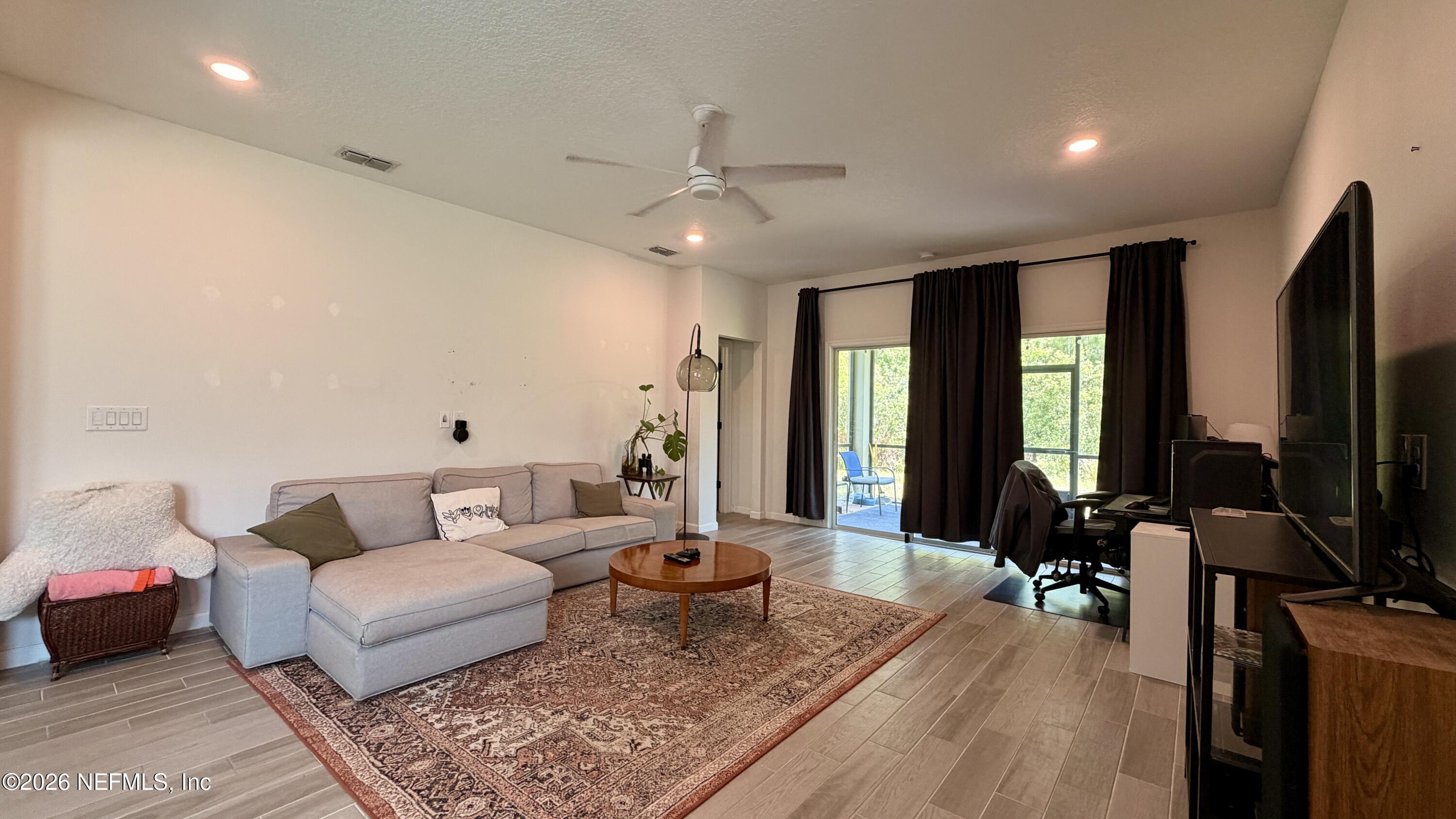 37 Saba Lane St. Augustine, FL 32092 - Photo 23 of 42 a living room with furniture and a flat screen tv