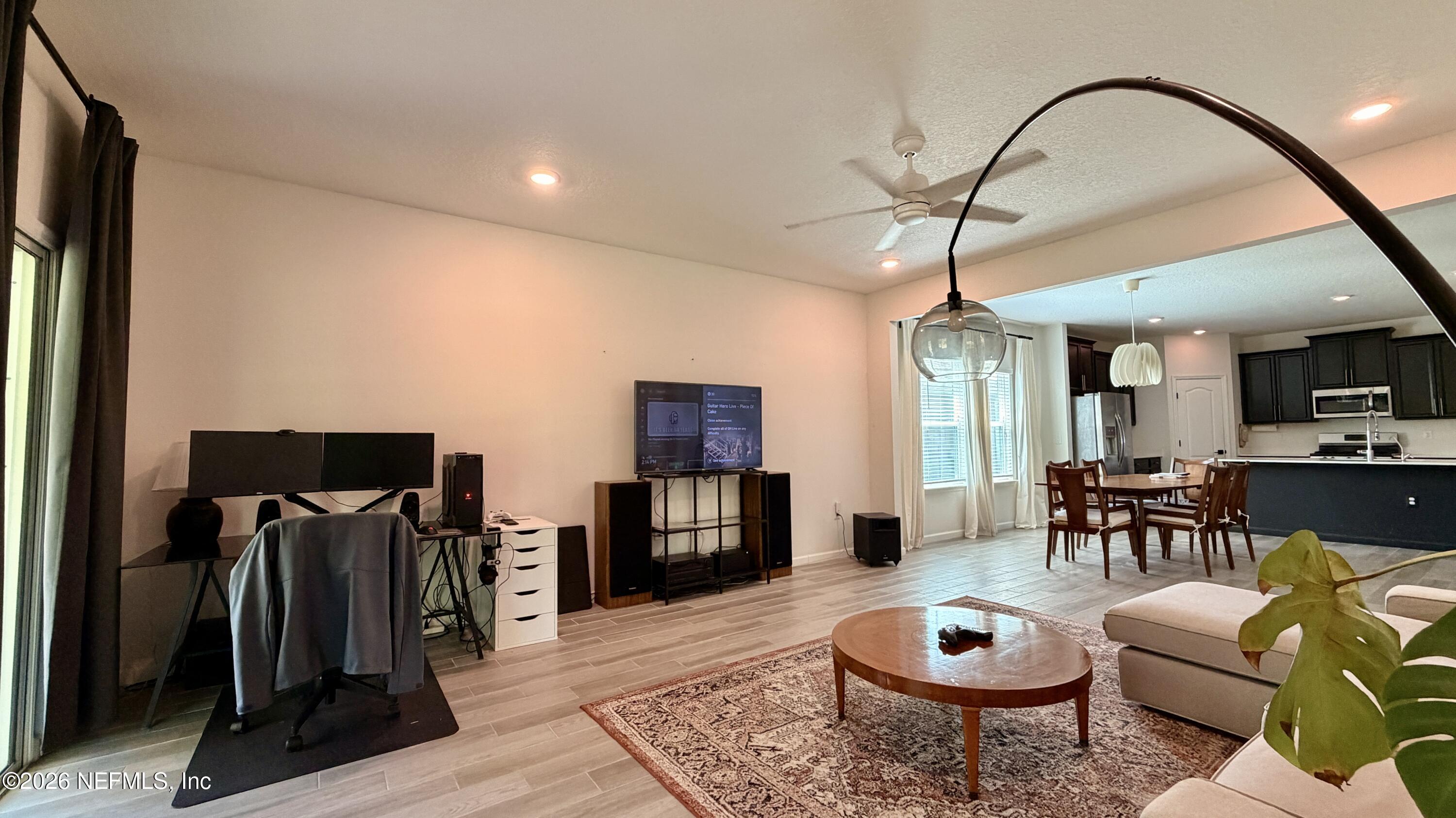 37 Saba Lane St. Augustine, FL 32092 - Photo 24 of 42 a living room with furniture a flat screen tv and a table