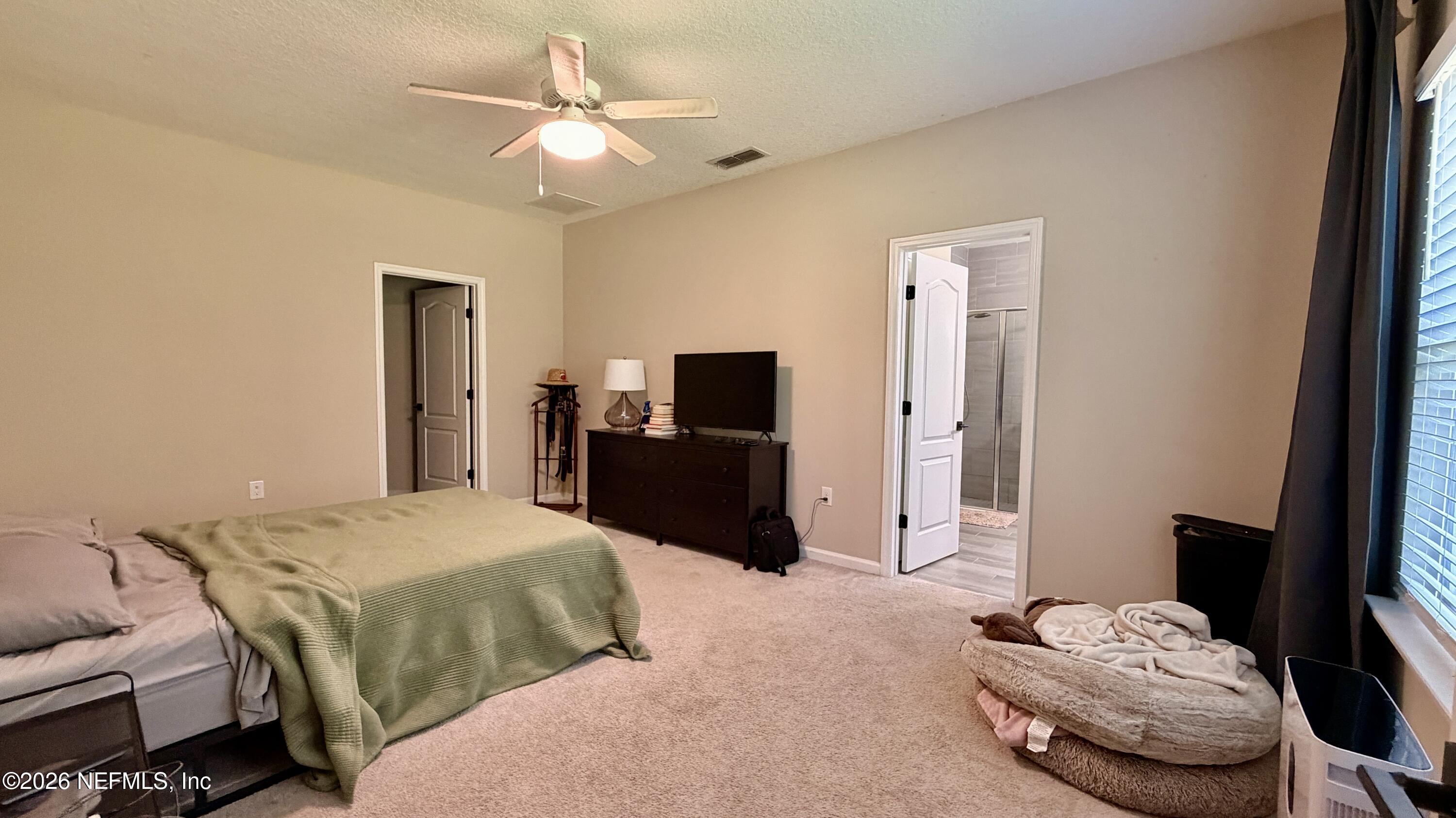 37 Saba Lane St. Augustine, FL 32092 - Photo 25 of 42 a bedroom with a bed and a television