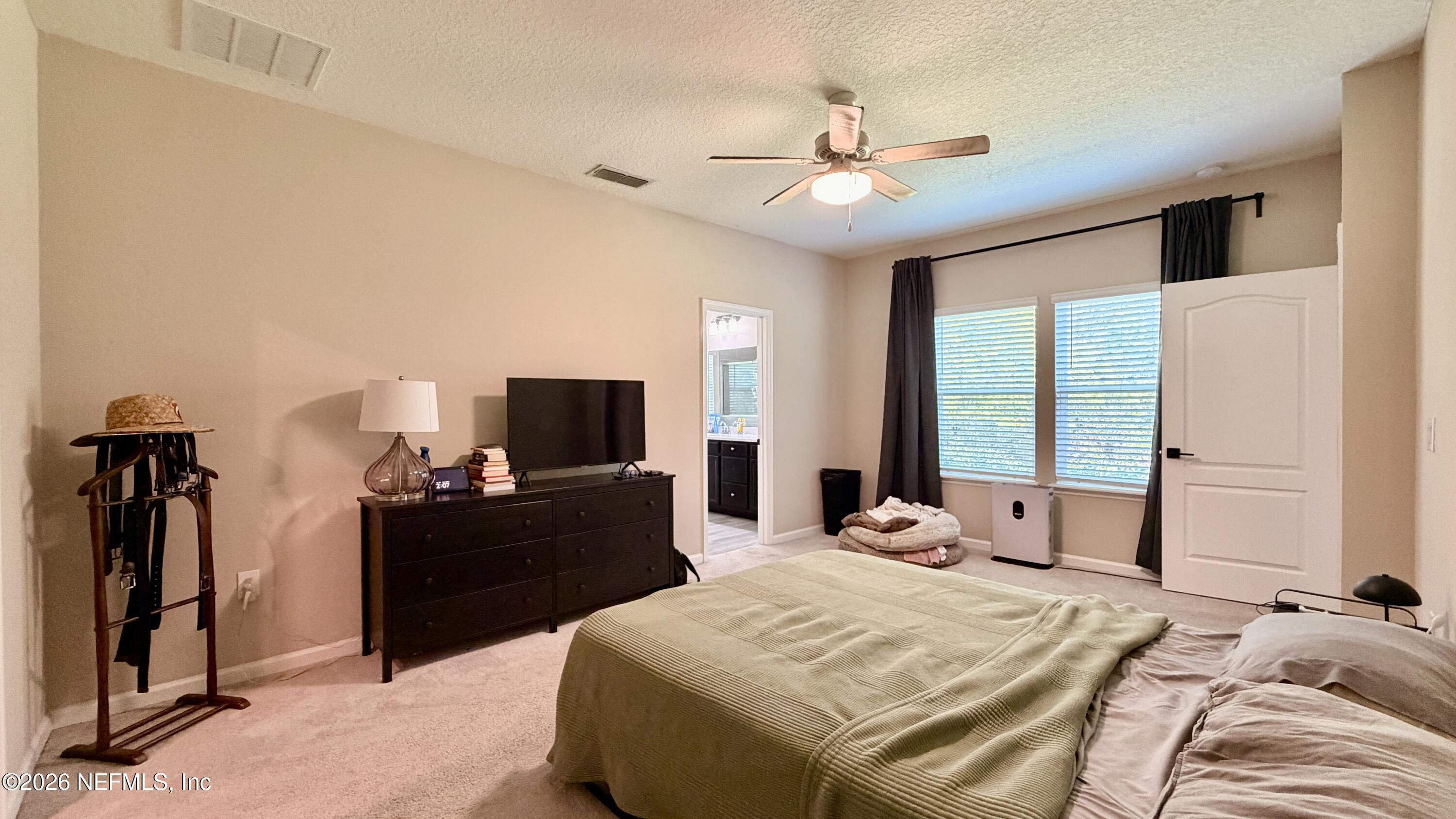 37 Saba Lane St. Augustine, FL 32092 - Photo 27 of 42 a bedroom with a bed and a flat tv screen on dresser