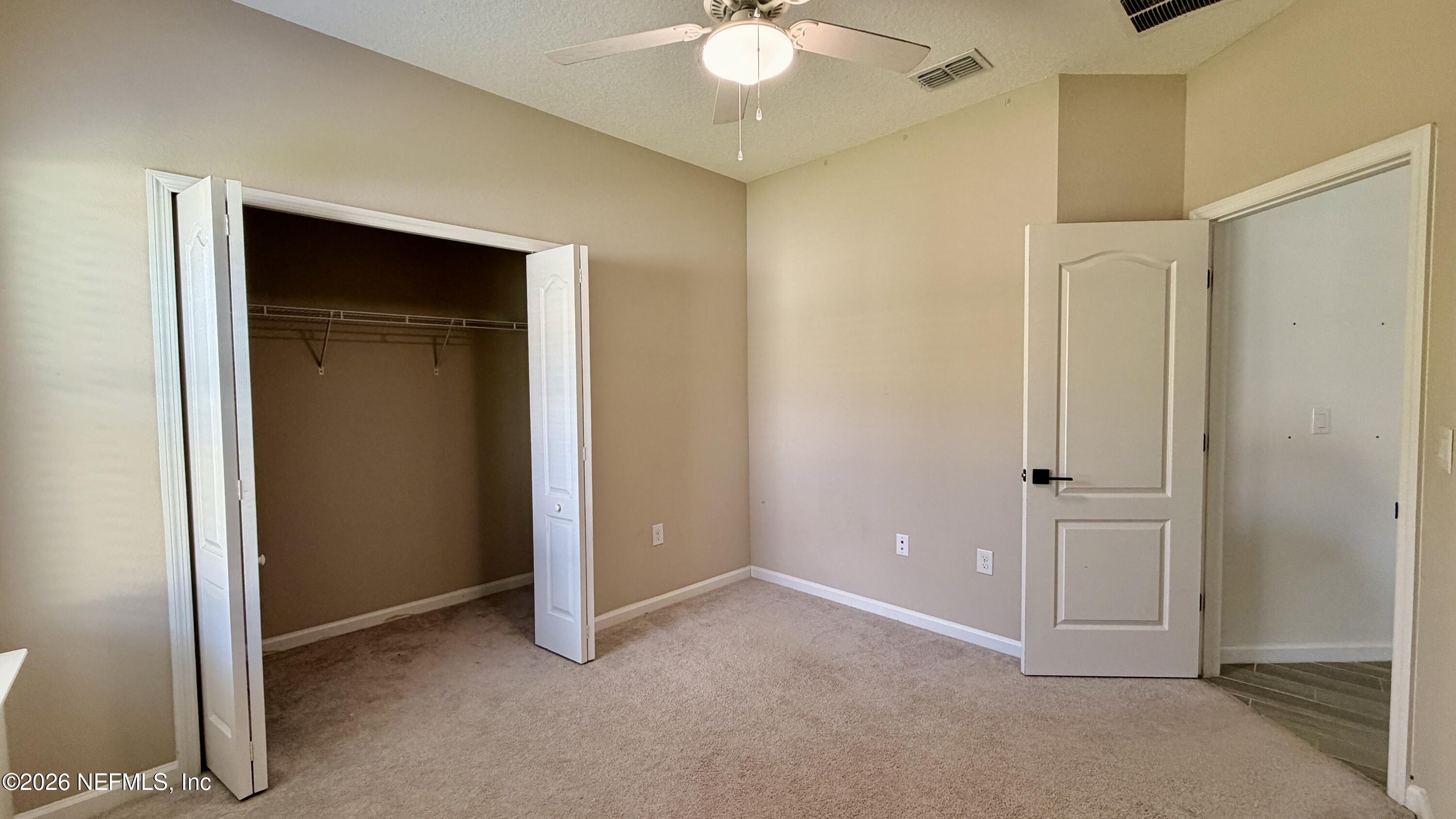 37 Saba Lane St. Augustine, FL 32092 - Photo 35 of 42 an empty room with closet and a chandelier fan