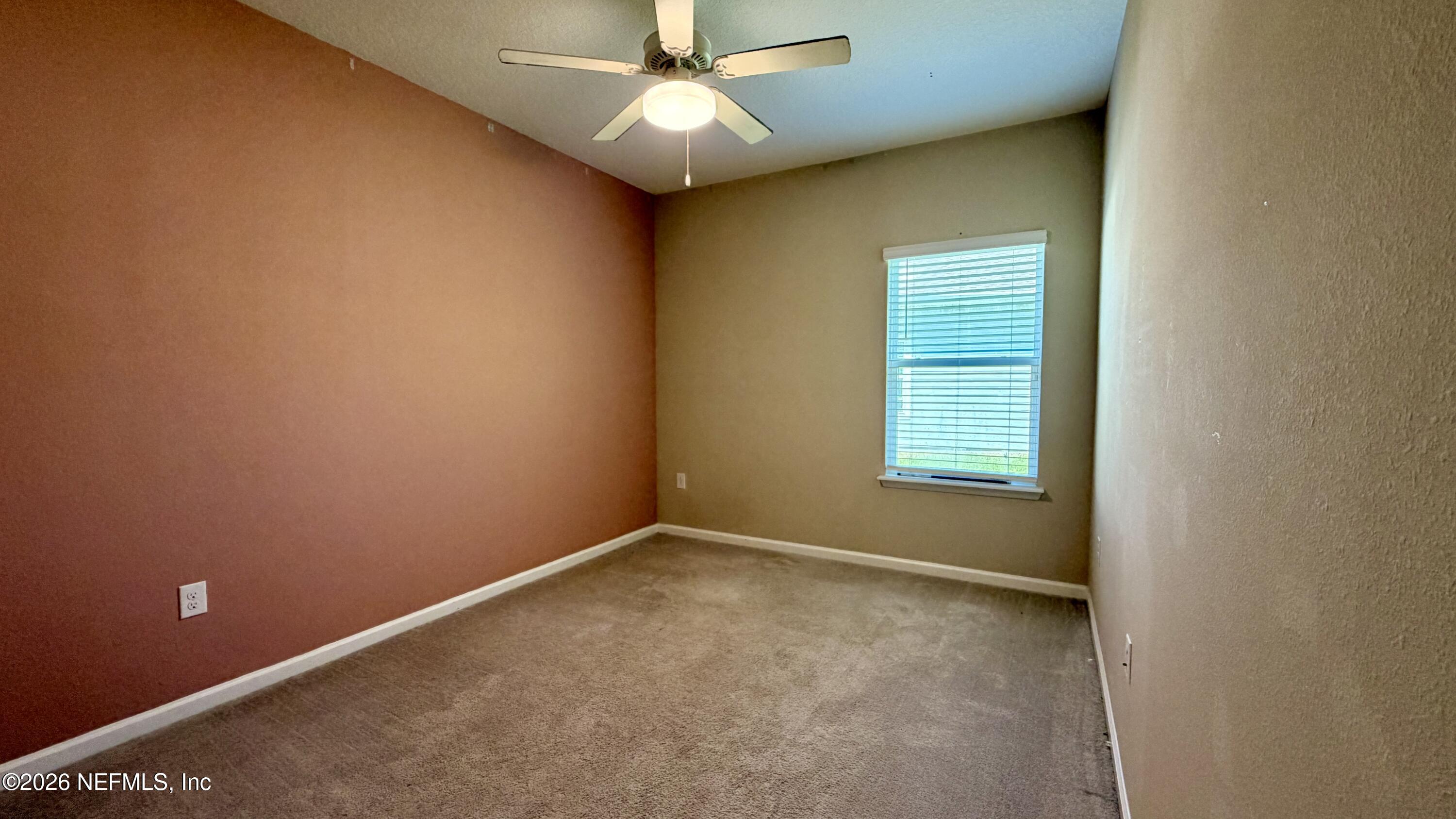 37 Saba Lane St. Augustine, FL 32092 - Photo 36 of 42 an empty room with a ceiling fan and a window