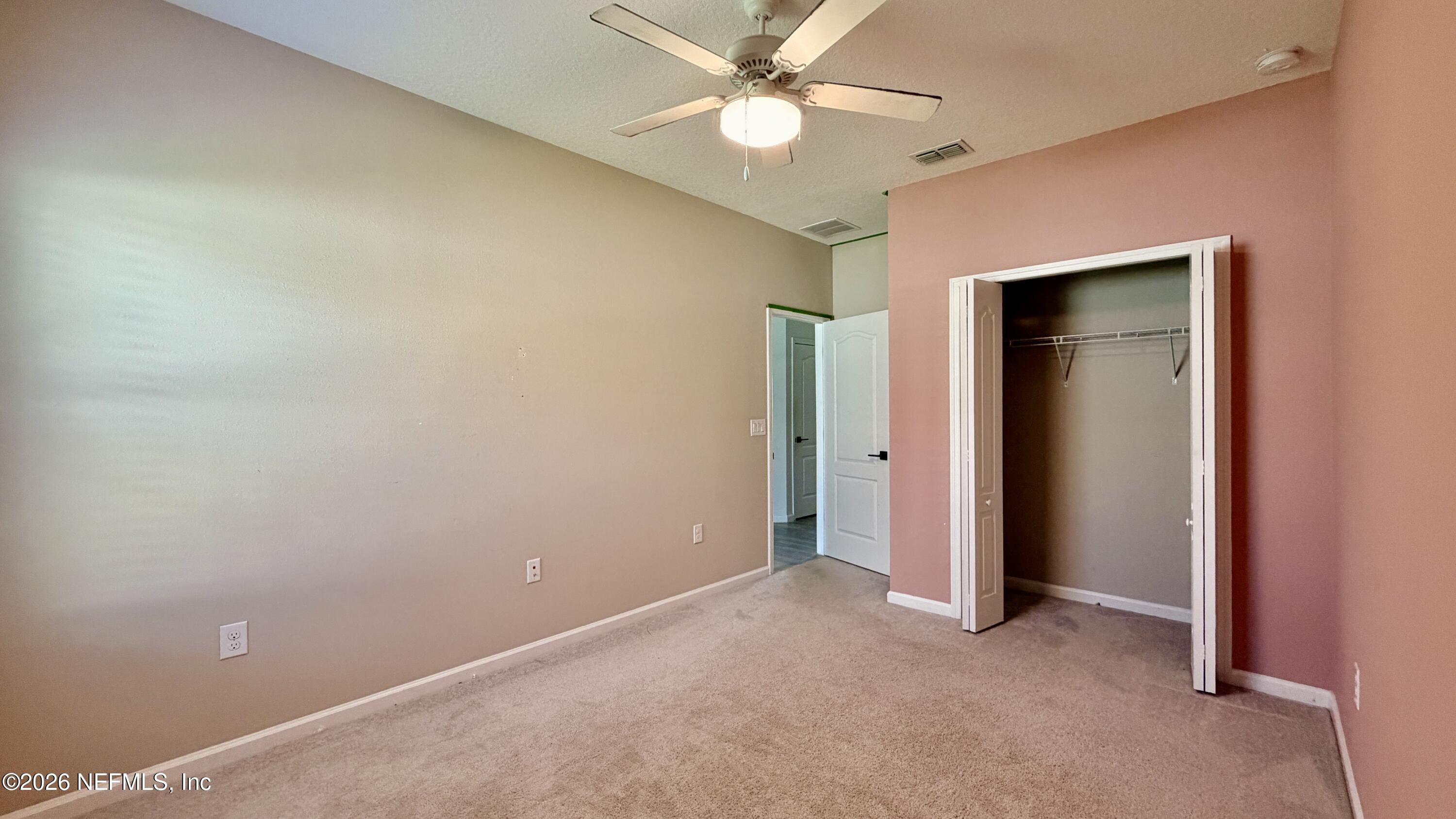 37 Saba Lane St. Augustine, FL 32092 - Photo 37 of 42 an empty room with closet and a ceiling fan