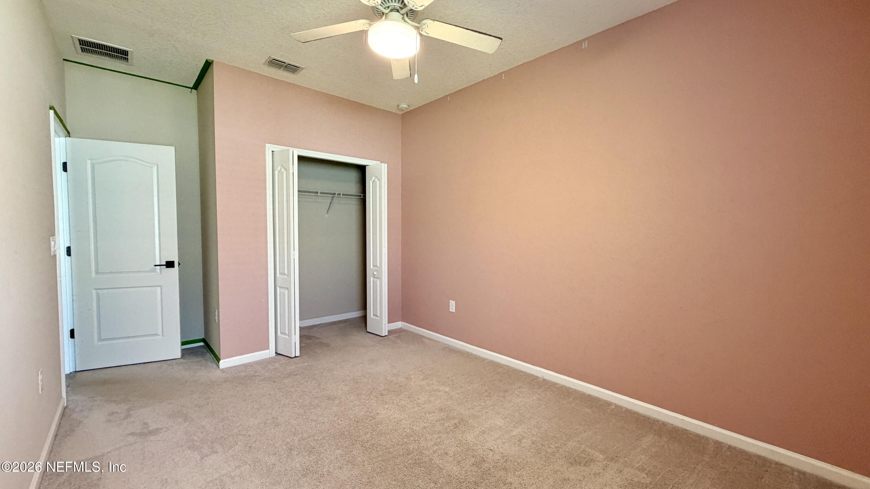 37 Saba Lane St. Augustine, FL 32092 - Photo 38 of 42 an empty room with a fan and a chandelier fan