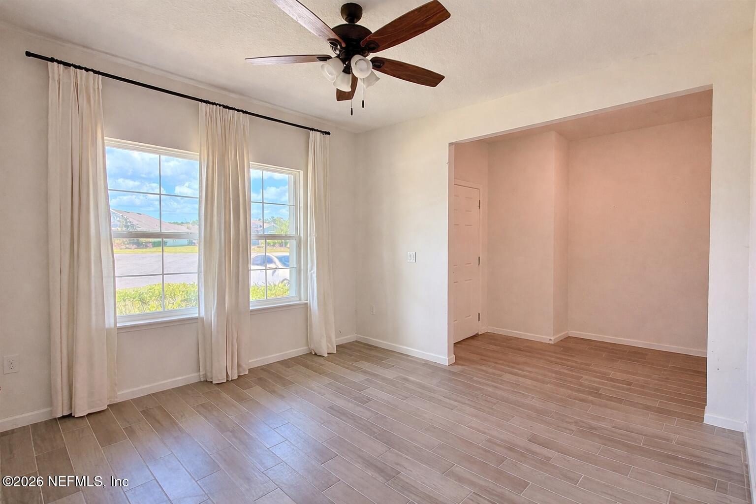 37 Saba Lane St. Augustine, FL 32092 - Photo 9 of 42 an empty room with wooden floor fan and windows