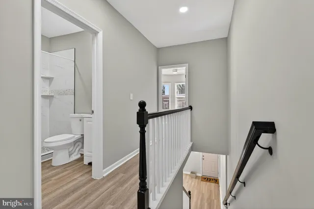 a bathroom with a toilet a sink and a mirror