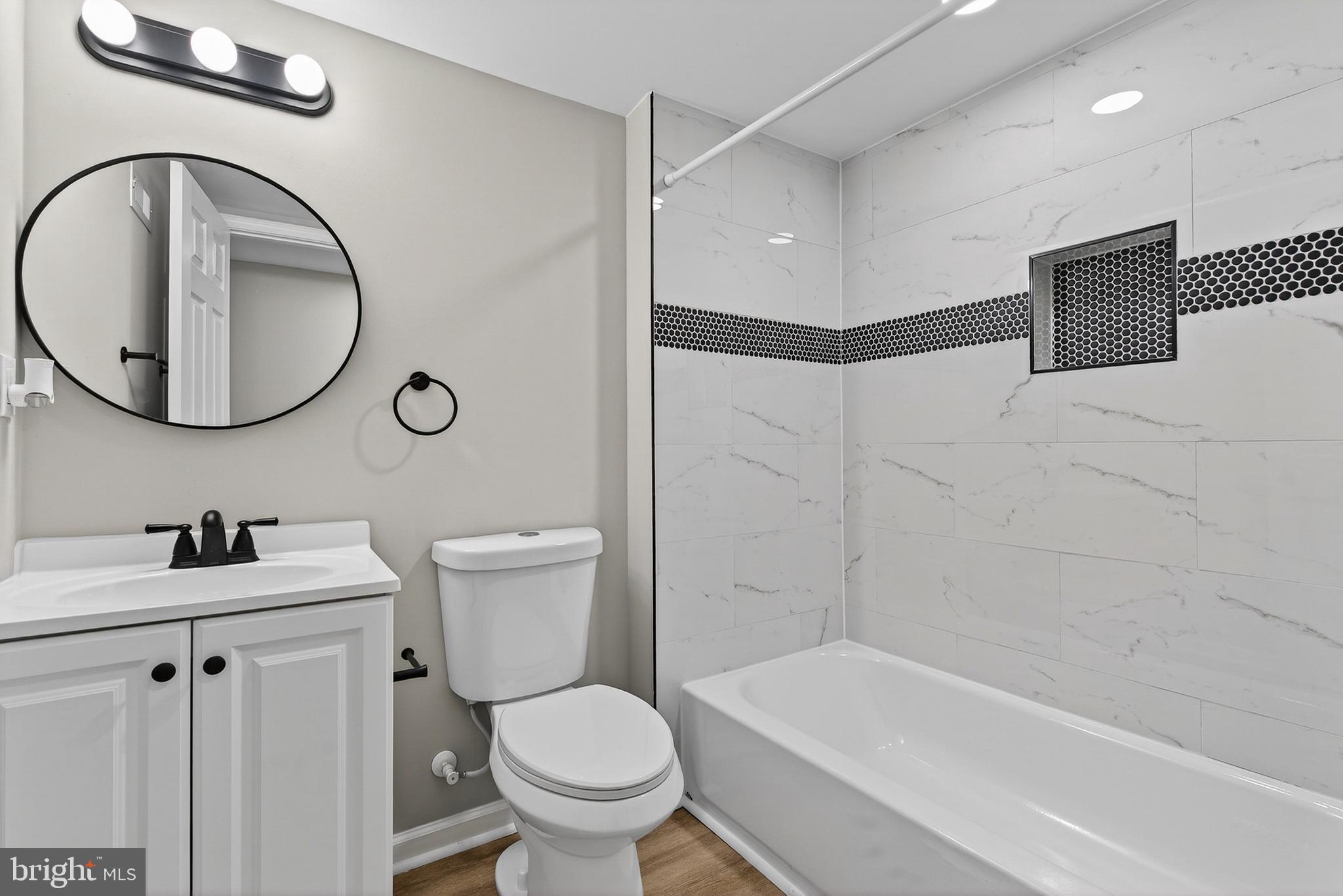 2822 Harlem Avenue Baltimore, MD 21216 - Photo 26 of 33 a bathroom with a sink a toilet and a mirror