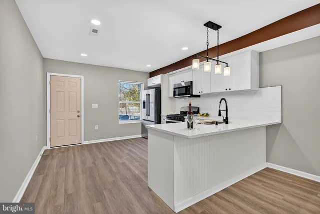 a view of kitchen with sink microwave and stove