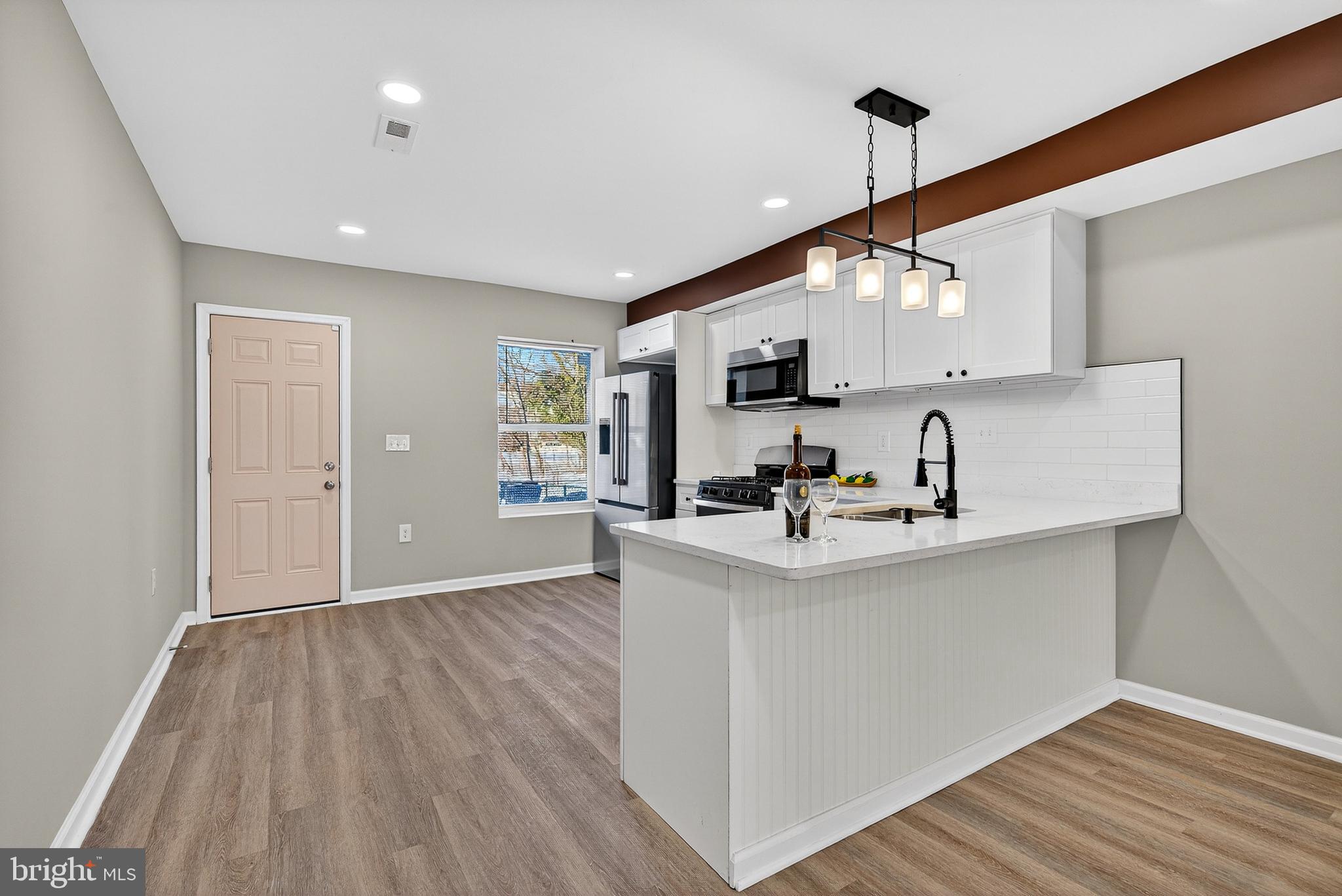 2822 Harlem Avenue Baltimore, MD 21216 - Photo 7 of 33 a view of kitchen with sink microwave and stove