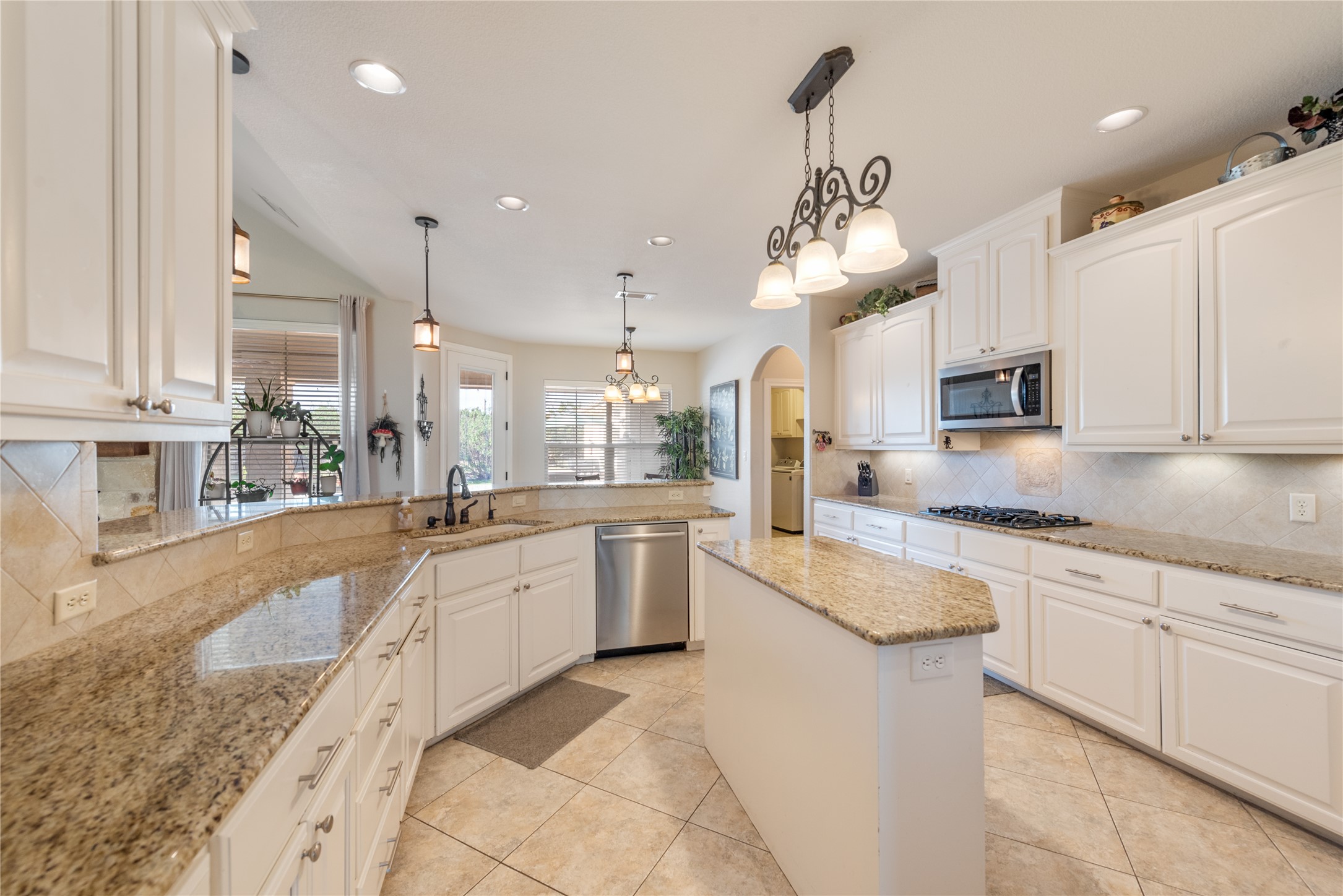 120 Layton Way Georgetown, TX 78633 - Photo 11 of 40 a large kitchen with granite countertop lots of white cabinets