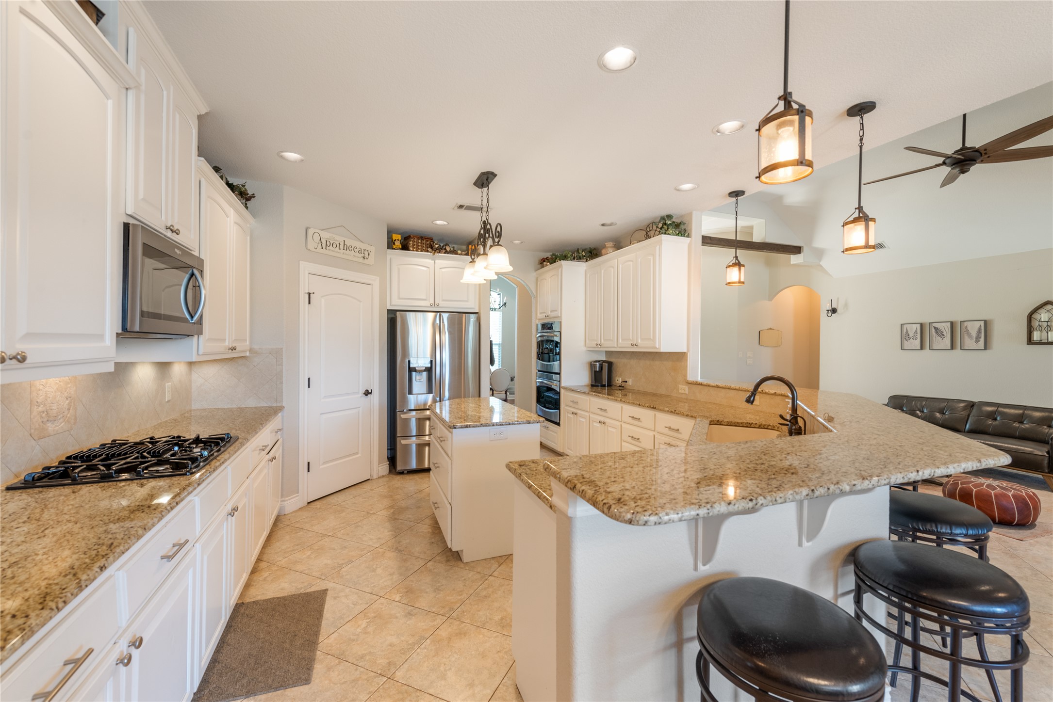 120 Layton Way Georgetown, TX 78633 - Photo 13 of 40 a kitchen with a dining table chairs sink and cabinets
