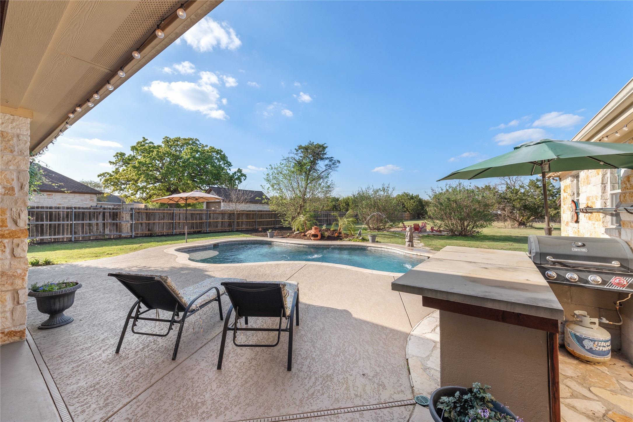 120 Layton Way Georgetown, TX 78633 - Photo 29 of 40 a swimming pool with outdoor seating and yard