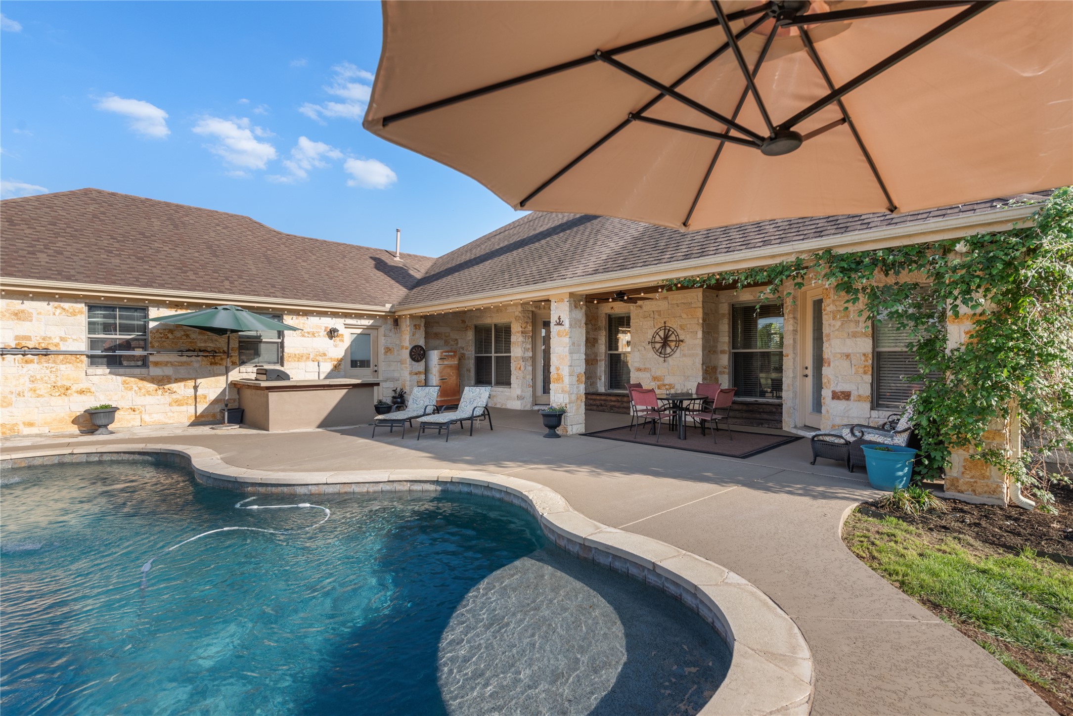 120 Layton Way Georgetown, TX 78633 - Photo 30 of 40 a view of a patio with table and chairs under an umbrella
