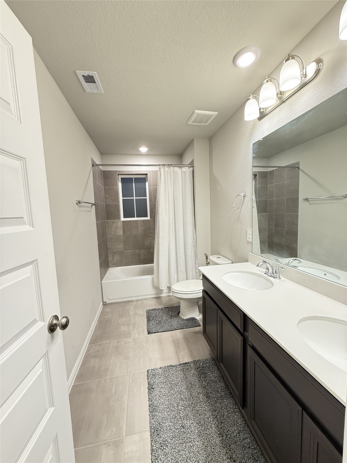 10807 Sugar Pne Lane Rosharon, TX 77583 - Photo 11 of 20 a bathroom with a sink a large mirror and a shower