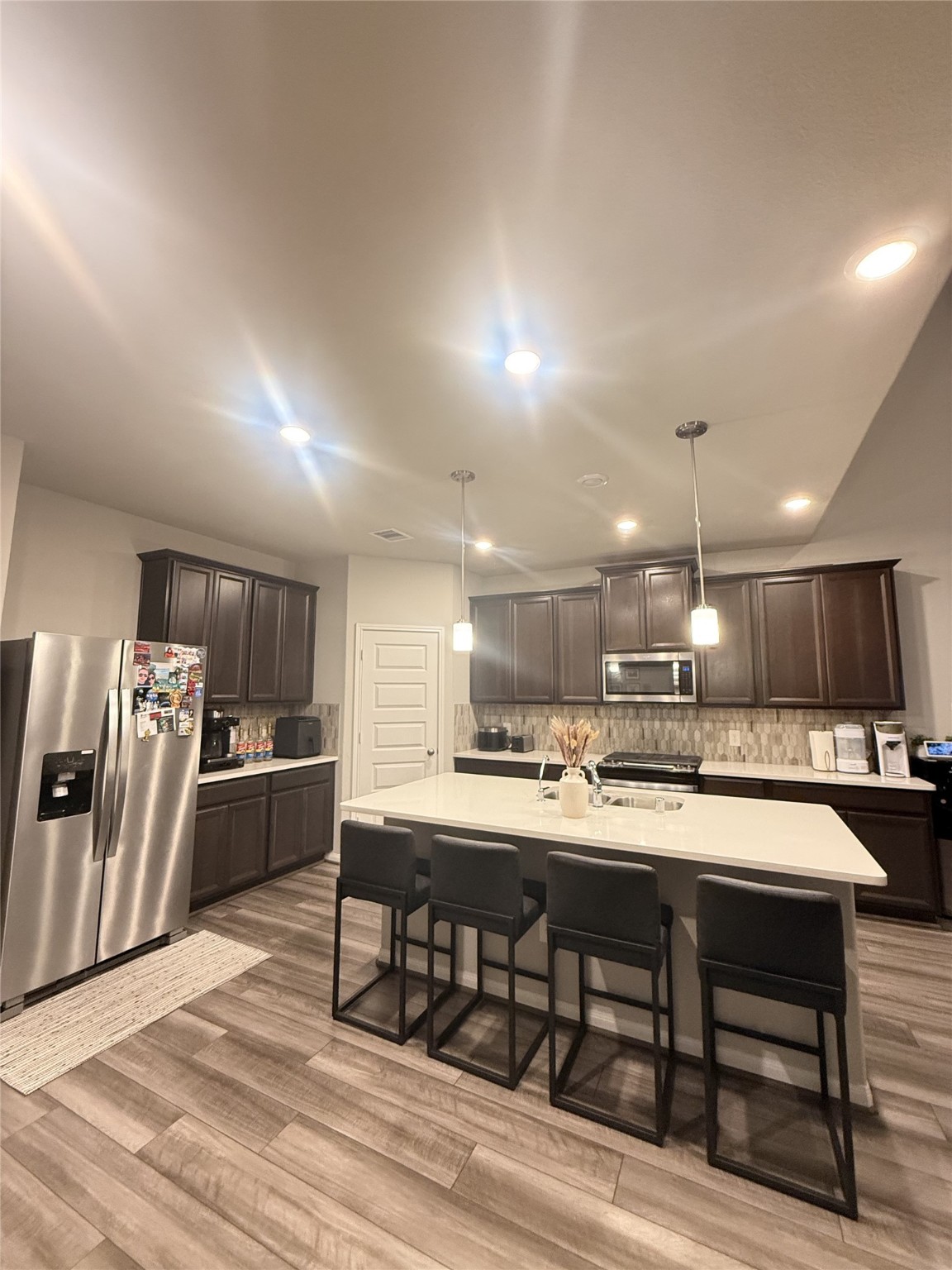 10807 Sugar Pne Lane Rosharon, TX 77583 - Photo 3 of 20 a kitchen with stainless steel appliances kitchen island granite countertop a sink and cabinets