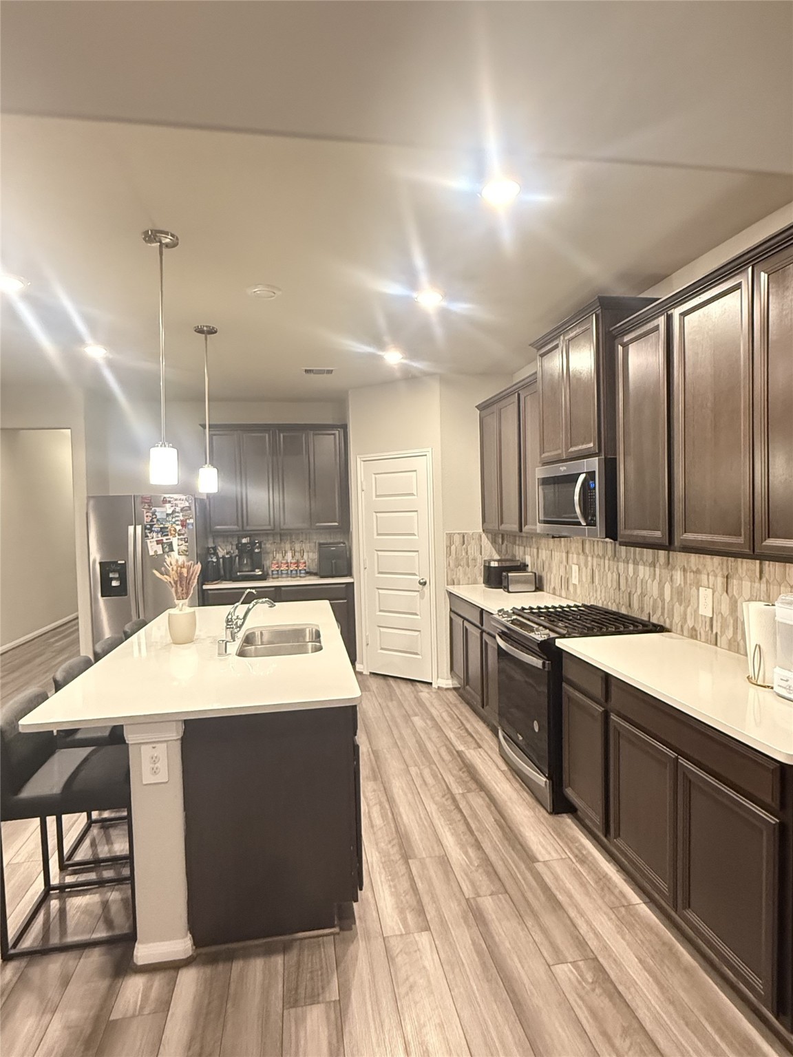 10807 Sugar Pne Lane Rosharon, TX 77583 - Photo 5 of 20 a large kitchen with a kitchen island a sink stainless steel appliances and cabinets