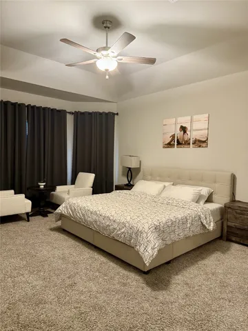 a large spacious bathroom with a large tub and mirror