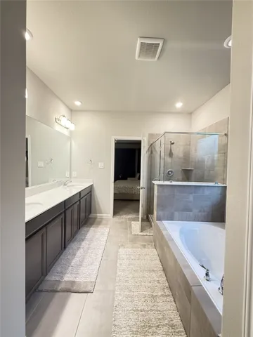 a bathroom with a sink a large mirror and a shower