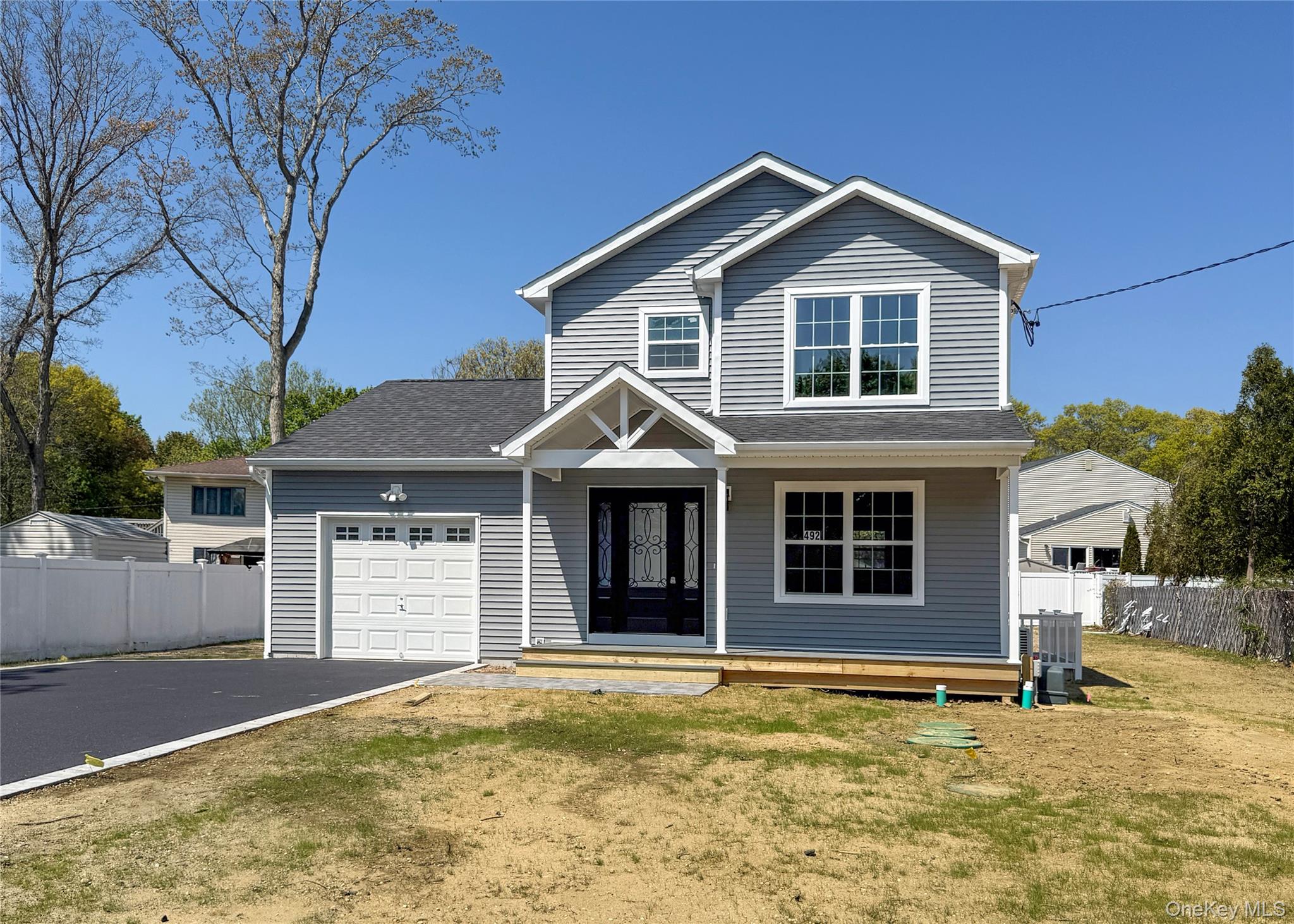 492 Blue Point Road Farmingville, NY 11738 - Photo 1 of 21 a front view of a house with a yard
