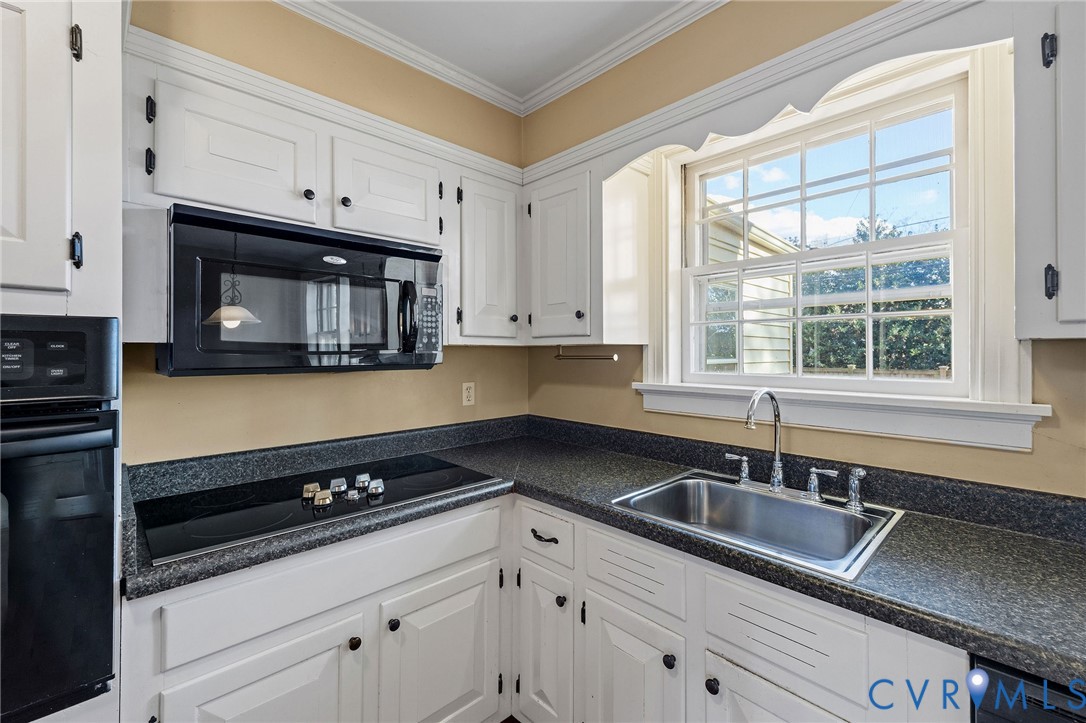 2831 Braidwood Road Richmond, VA 23225 - Photo 19 of 50 a kitchen with granite countertop white cabinets and a sink
