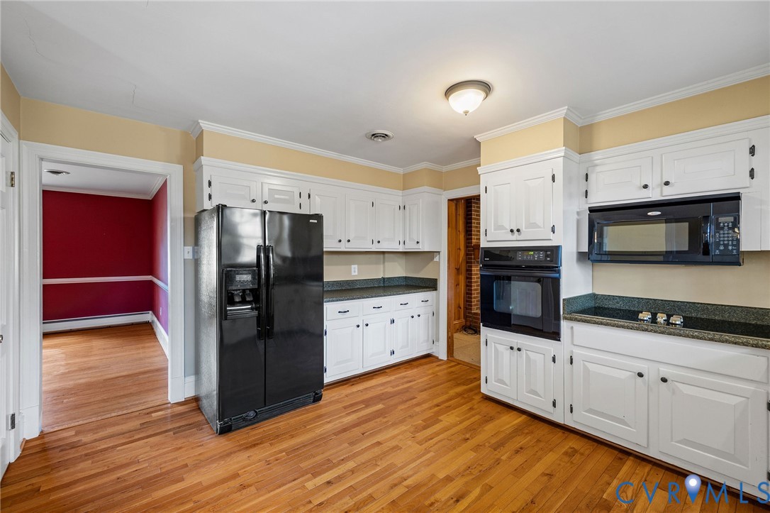 2831 Braidwood Road Richmond, VA 23225 - Photo 20 of 50 a kitchen with granite countertop a refrigerator and a stove top oven